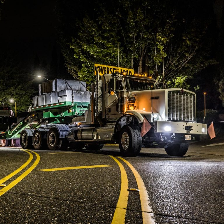 Omega Morgan semi truck on a night highway transport run